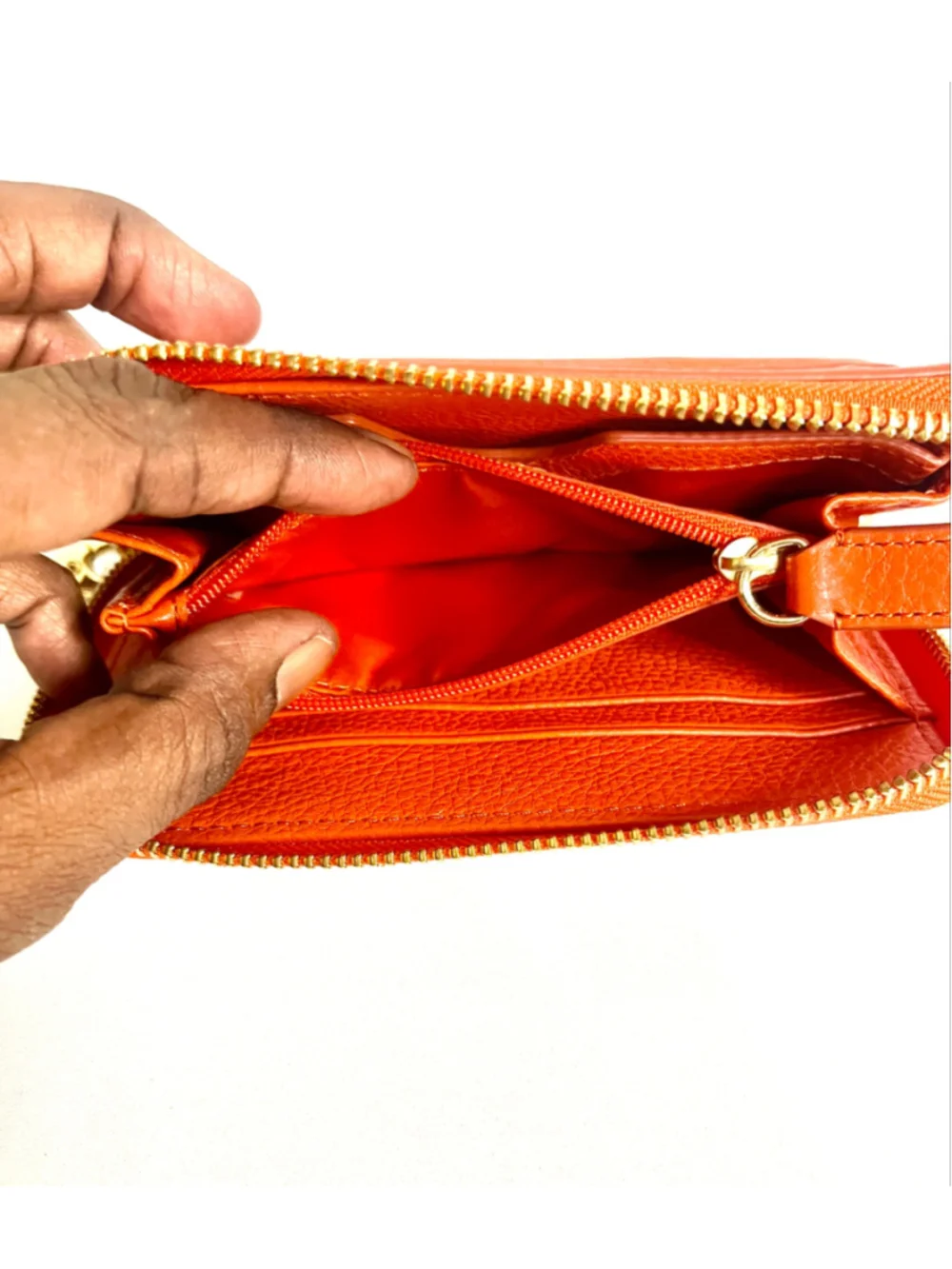 Tory Burch Amanda zip-around wallet featuring vibrant orange pebbled leather.
